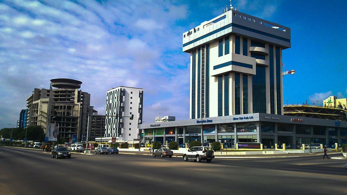 A street in Airport City, Accra, with a modern office tower
