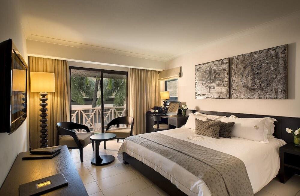 A guest room at Labadi Beach Hotel with a balcony onto the palms