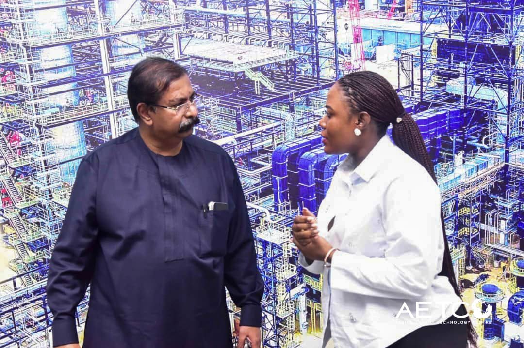 Two visitors talk in front of the processing units on a visit to the Dangote Petroleum Refinery, Lagos, 2024
