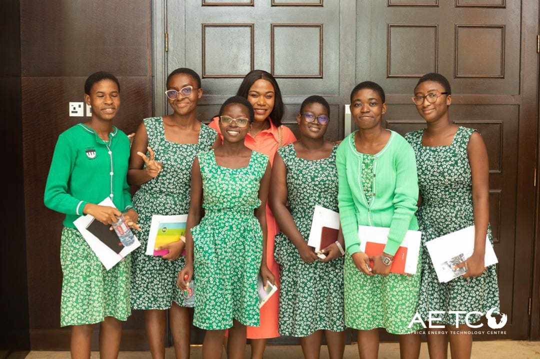 Scholarship recipients in matching dresses stand together at the launch of the Minerals Income Investment Fund's Women in Mining scholarship scheme, 2024