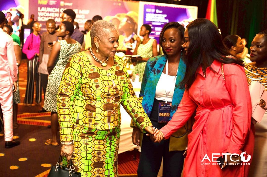 Two women greet each other warmly at the launch of the Minerals Income Investment Fund's Women in Mining scholarship scheme, 2024