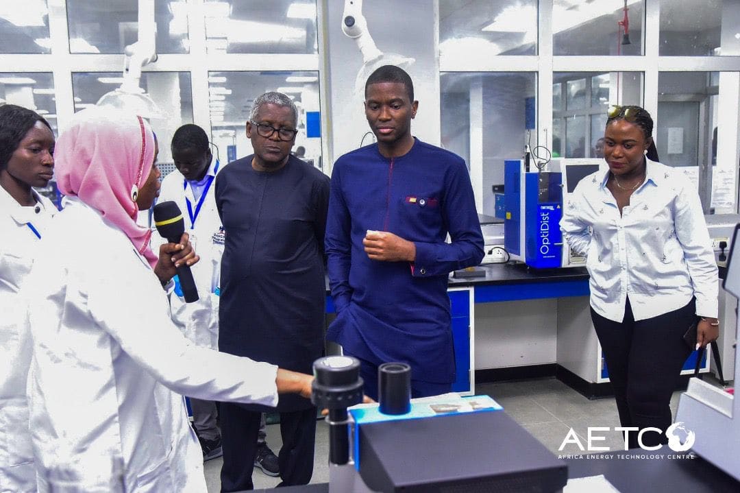 Visitors in white coats in a laboratory on a visit to the Dangote Petroleum Refinery, Lagos, 2024