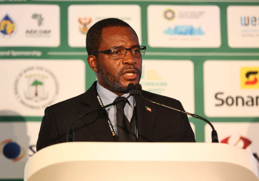 Gabriel Mbaga Obiang Lima speaks at a lectern in front of conference sponsor boards