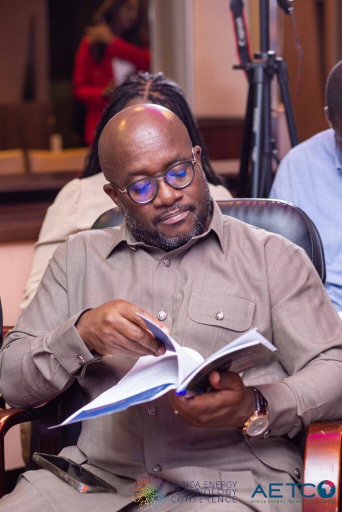 A guest in glasses reads the programme at the press launch of the first Africa Energy Technology Conference, Alisa Hotel, Accra, June 2023