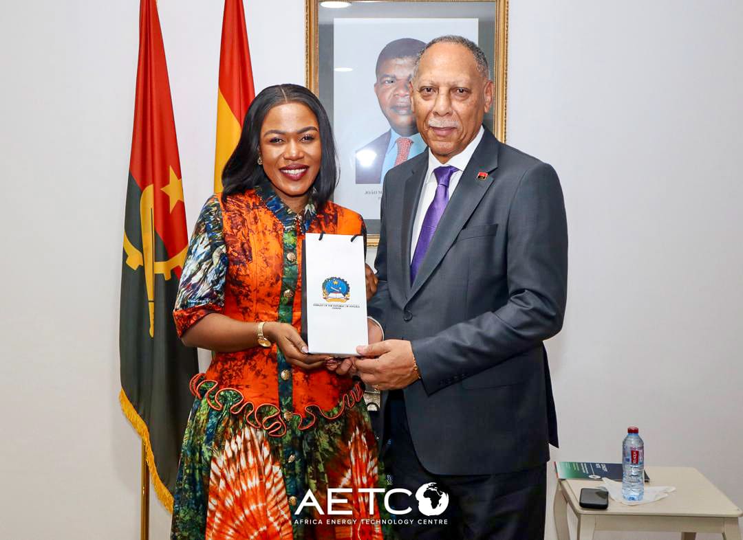 Emelia Akumah and Ambassador Rui Orlando Xavier hold a gift at the Embassy of Angola in Accra
