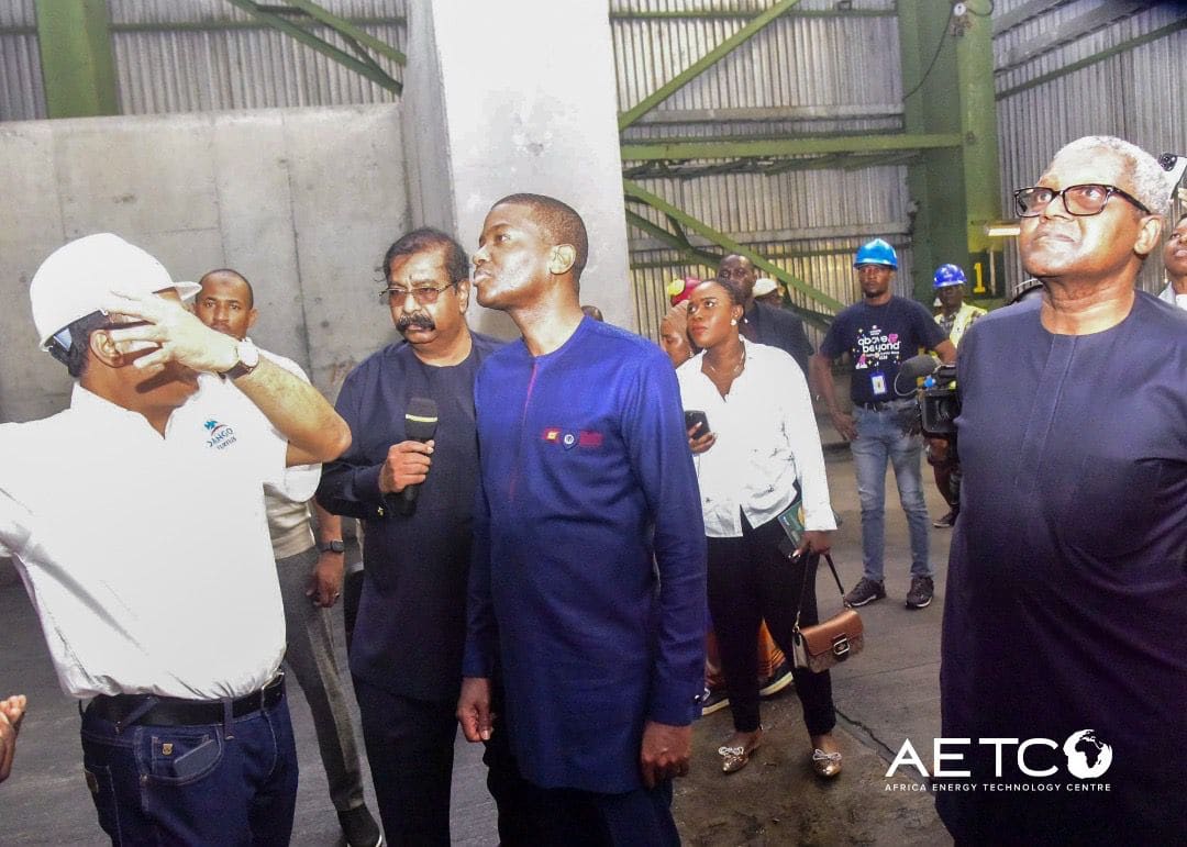 Visitors in hard hats talk with refinery staff on a visit to the Dangote Petroleum Refinery, Lagos, 2024
