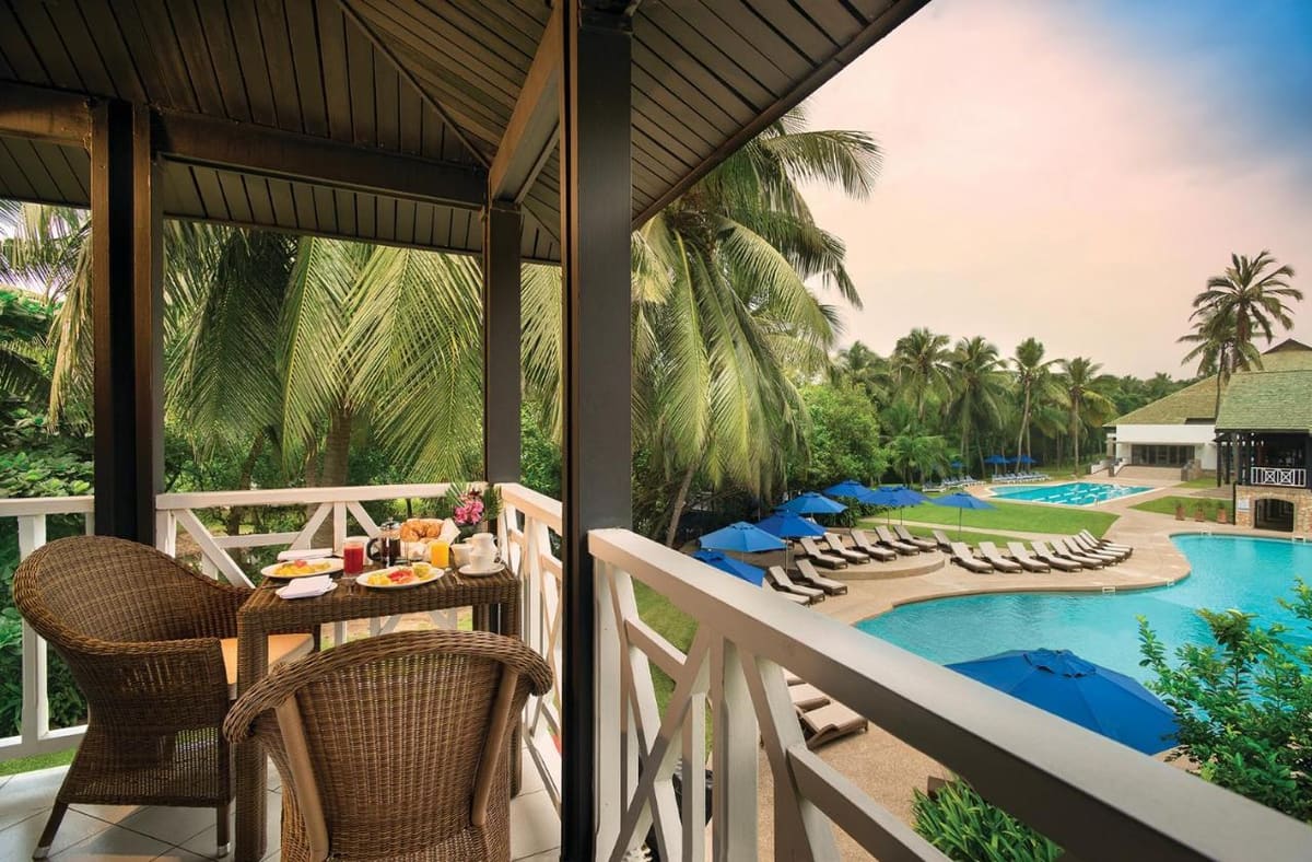 Breakfast on a veranda table above the pool at Labadi Beach Hotel
