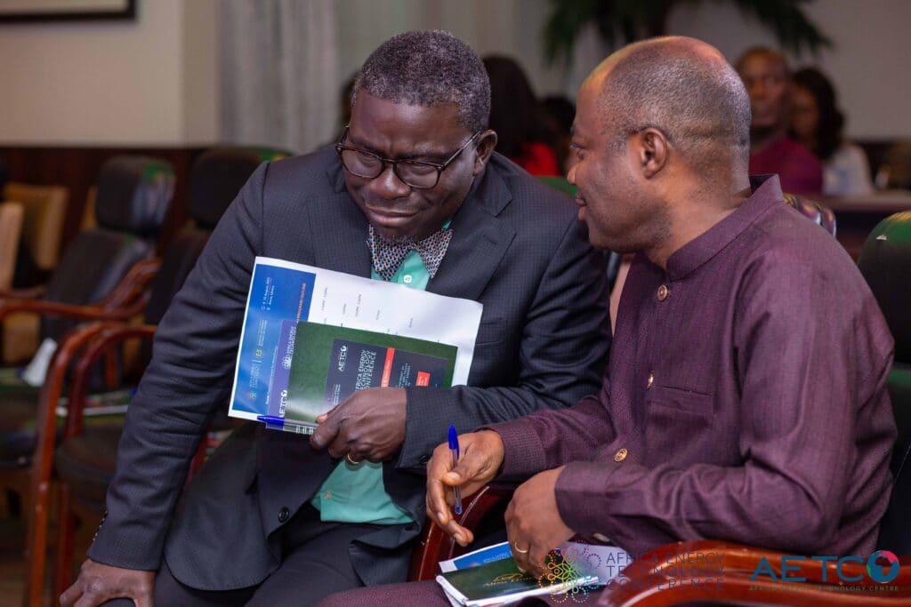 Two guests look through the conference brochure at the press launch of the first Africa Energy Technology Conference, Alisa Hotel, Accra, June 2023