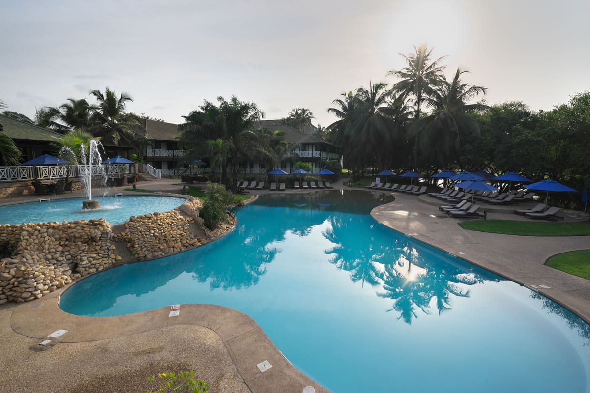 The leisure pool at Labadi Beach Hotel, with its fountain and sun loungers
